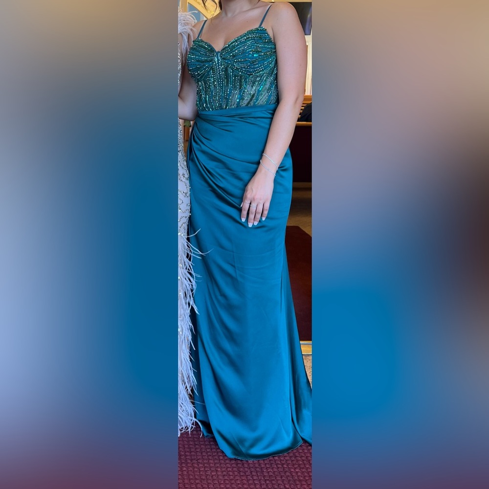 Emerald gown with beaded corset top and side cape.
